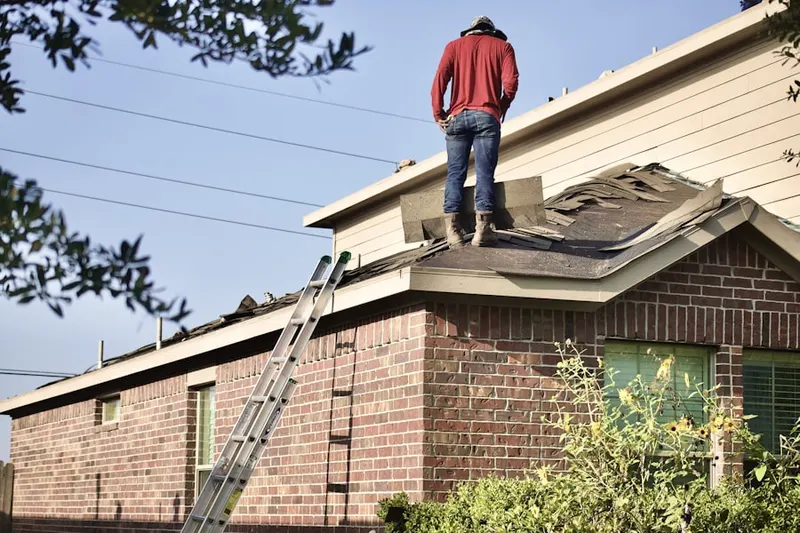 Professional roofer working on a residential roof in Whitestown